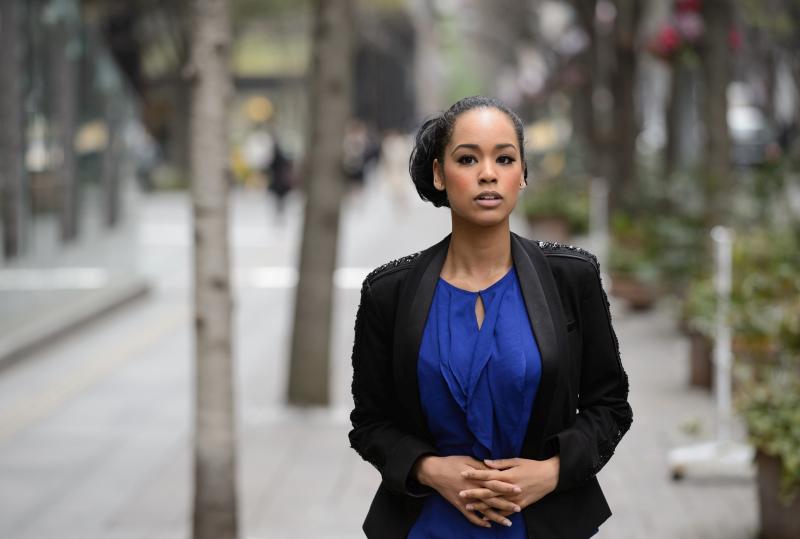 Ariana Miyamoto, Japanese representative of Miss Universe 2015, walks along the sidewalk in Tokyo, Japan, on Friday, April 3, 2015. Photographer: Akio Kon/ Bloomberg